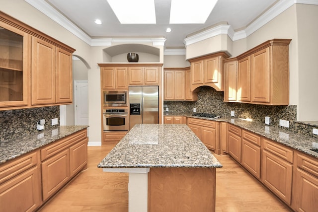 3818 Rose Grove Ln, Katy, TX 77494 - kitchen featuring appliances with stainless steel finishes, a center island, stone countertops, decorative backsplash, and ornamental molding
