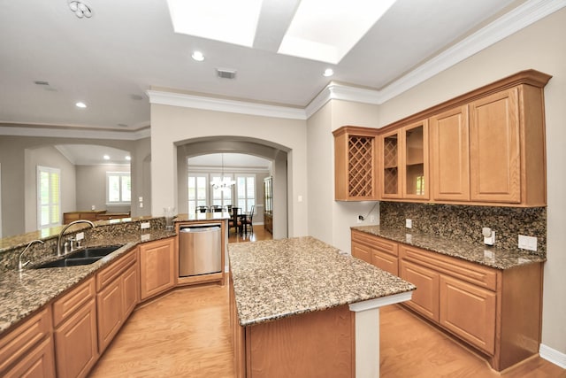 3818 Rose Grove Ln, Katy, TX 77494 - kitchen featuring stainless steel dishwasher, a sink, arched walkways, stone countertops, and crown molding