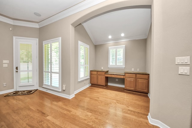 3818 Rose Grove Ln, Katy, TX 77494 - unfurnished office with arched walkways, crown molding, light wood-type flooring, baseboards, and built in desk
