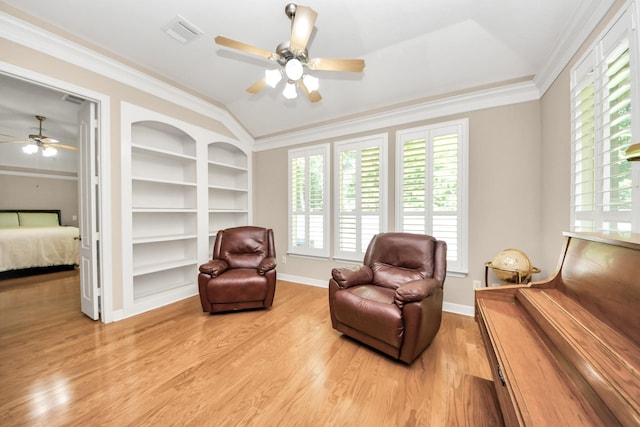 3818 Rose Grove Ln, Katy, TX 77494 - living area featuring a ceiling fan, plenty of natural light, built in features, light wood finished floors, and crown molding