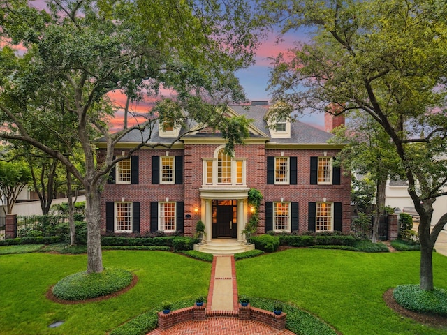 8722 Stable Crest Blvd, Houston, TX 77024 - colonial house featuring a front yard, brick siding, and a chimney