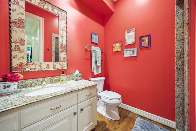 8722 Stable Crest Blvd, Houston, TX 77024 - bathroom with toilet, baseboards, wood finished floors, and vanity