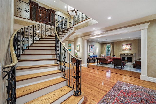 8722 Stable Crest Blvd, Houston, TX 77024 - stairway with crown molding, wood finished floors, baseboards, a fireplace, and recessed lighting