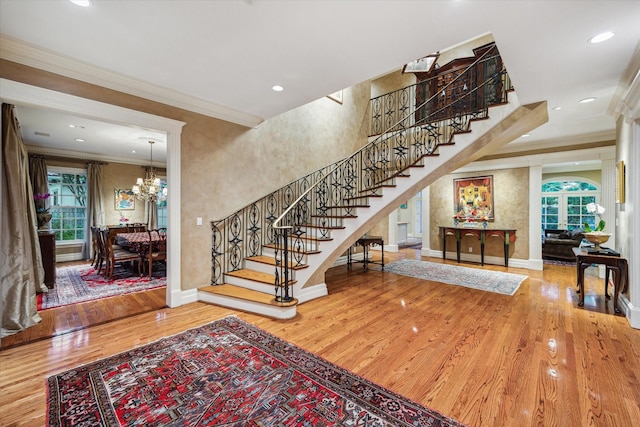 8722 Stable Crest Blvd, Houston, TX 77024 - foyer with ornamental molding, wood finished floors, stairway, baseboards, and a chandelier