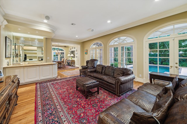 8722 Stable Crest Blvd, Houston, TX 77024 - living room featuring french doors, ornamental molding, light wood-style flooring, and recessed lighting