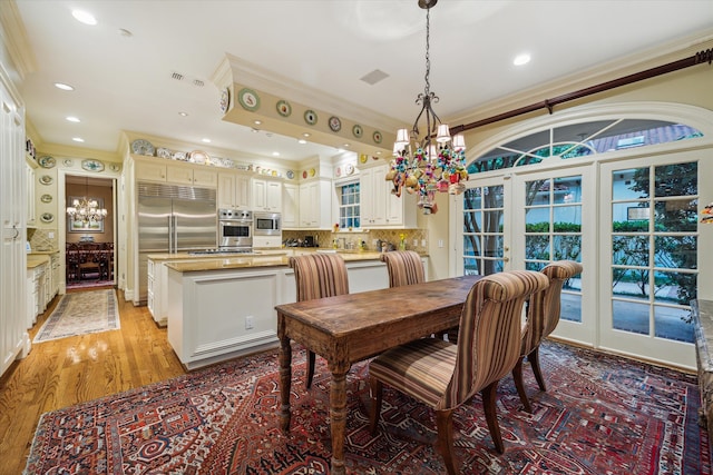 8722 Stable Crest Blvd, Houston, TX 77024 - dining room featuring crown molding, a chandelier, recessed lighting, and light wood-type flooring