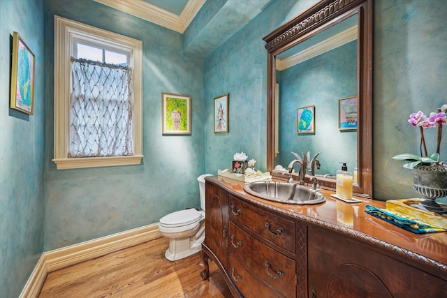 8722 Stable Crest Blvd, Houston, TX 77024 - bathroom with wood finished floors, ornamental molding, toilet, baseboards, and vanity