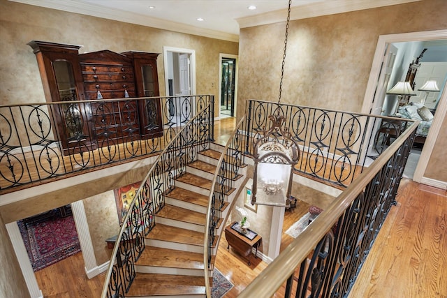 8722 Stable Crest Blvd, Houston, TX 77024 - stairs with wood finished floors, ornamental molding, baseboards, a chandelier, and recessed lighting