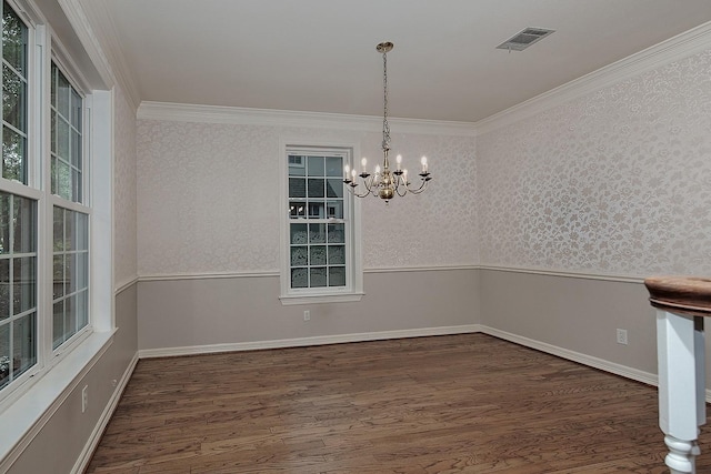 unfurnished dining area featuring a chandelier, wood finished floors, and ornamental molding
