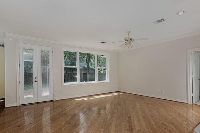 unfurnished living room featuring ornamental molding, baseboards, french doors, and plenty of natural light