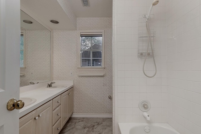 bathroom with double vanity, a sink, shower / bath combination, visible vents, and marble finish floor