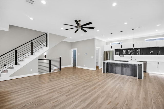 604 W 28th St Unit A, Houston, TX 77008 - unfurnished living room featuring a ceiling fan, light wood-style flooring, recessed lighting, and a sink