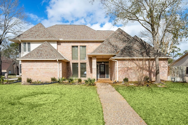 12414 Laneview Dr, Houston, TX 77070 - view of front facade with a shingled roof, brick siding, and a front yard