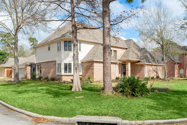 12414 Laneview Dr, Houston, TX 77070 - view of front facade with a front yard, a shingled roof, brick siding, and an attached garage