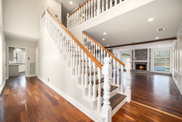 12414 Laneview Dr, Houston, TX 77070 - stairs with visible vents, a fireplace, baseboards, and hardwood / wood-style flooring