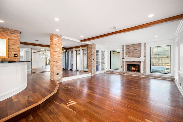 12414 Laneview Dr, Houston, TX 77070 - unfurnished living room featuring wood finished floors, a fireplace, decorative columns, visible vents, and ornamental molding