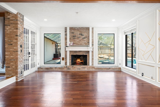 12414 Laneview Dr, Houston, TX 77070 - unfurnished living room with ornamental molding, hardwood / wood-style flooring, a brick fireplace, and recessed lighting