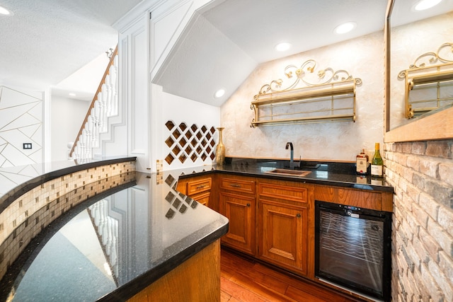 12414 Laneview Dr, Houston, TX 77070 - bar featuring a sink, lofted ceiling, hardwood / wood-style flooring, indoor wet bar, and beverage cooler