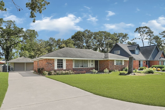 view of front of property with a detached garage, a front yard, and brick siding