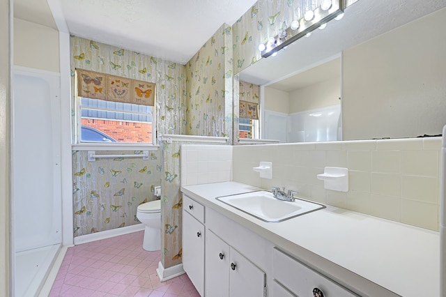 bathroom with wallpapered walls, toilet, tile patterned flooring, vanity, and baseboards
