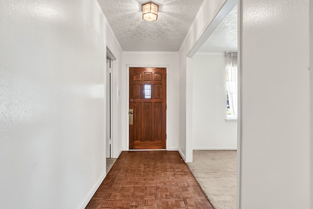 foyer with baseboards, healthy amount of natural light, and a textured ceiling