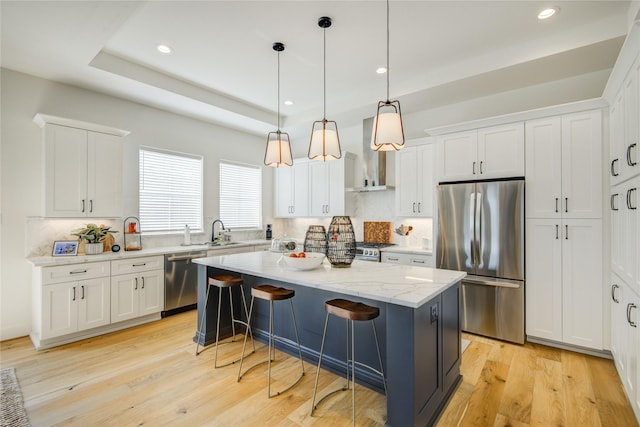kitchen with stainless steel appliances, a center island, backsplash, white cabinetry, and recessed lighting