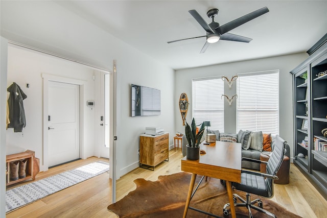 office space with light wood finished floors and a ceiling fan