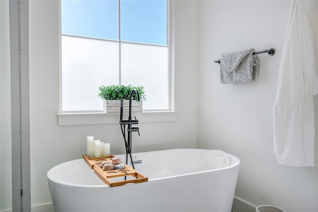 bathroom with a sink and a soaking tub