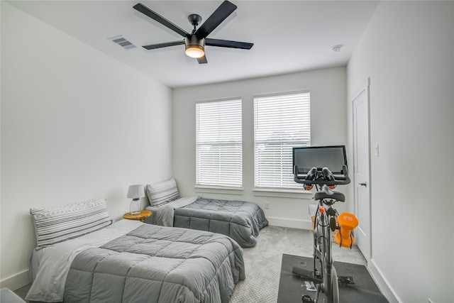 carpeted bedroom with baseboards and a ceiling fan