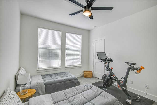 bedroom featuring baseboards, carpet flooring, and a ceiling fan