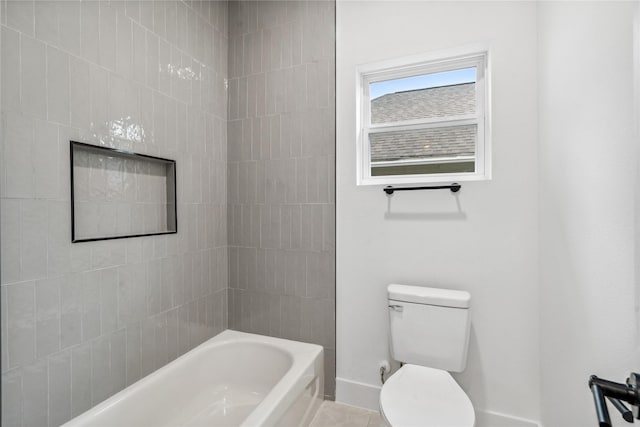 full bath with toilet, baseboards, and shower / bath combination
