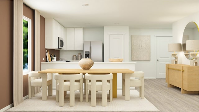 kitchen with appliances with stainless steel finishes, baseboards, white cabinetry, light countertops, and light wood-type flooring