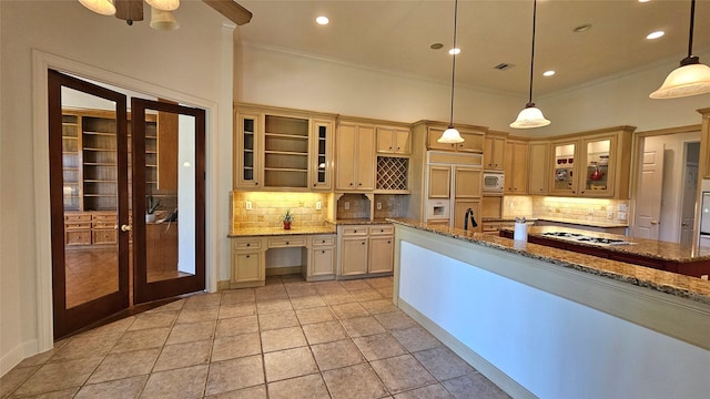 108 W Pines Dr, Montgomery, TX 77356 - kitchen with ornamental molding, white appliances, tasteful backsplash, stone countertops, and french doors