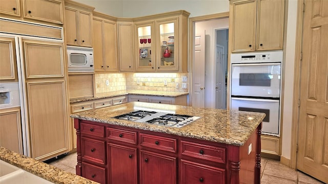 108 W Pines Dr, Montgomery, TX 77356 - kitchen featuring built in appliances, light tile patterned floors, tasteful backsplash, and dark brown cabinets