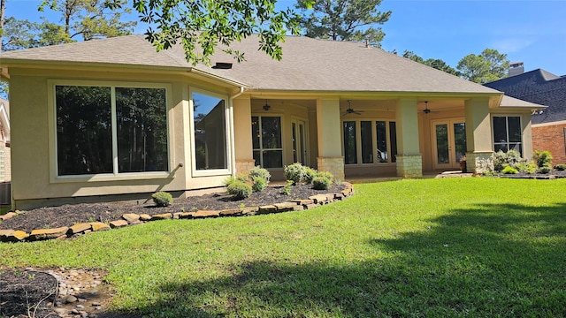 108 W Pines Dr, Montgomery, TX 77356 - rear view of house featuring ceiling fan, a lawn, roof with shingles, and stucco siding