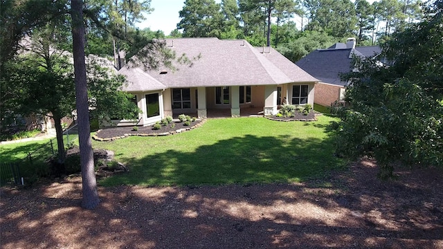 108 W Pines Dr, Montgomery, TX 77356 - rear view of property featuring a lawn, a porch, stucco siding, and a chimney
