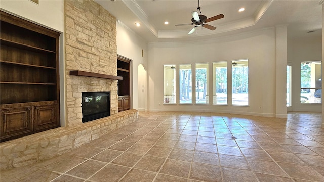 108 W Pines Dr, Montgomery, TX 77356 - unfurnished living room with a high ceiling, a fireplace, a ceiling fan, ornamental molding, and built in shelves