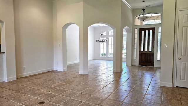 108 W Pines Dr, Montgomery, TX 77356 - entryway featuring healthy amount of natural light, a high ceiling, ornamental molding, baseboards, and arched walkways