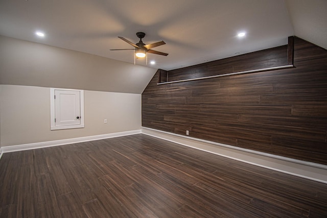 bonus room with lofted ceiling, a ceiling fan, recessed lighting, baseboards, and dark wood-style flooring