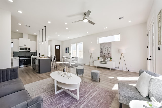 5017 Hardway St, Houston, TX 77092 - living area with light wood-style floors, a ceiling fan, recessed lighting, and baseboards