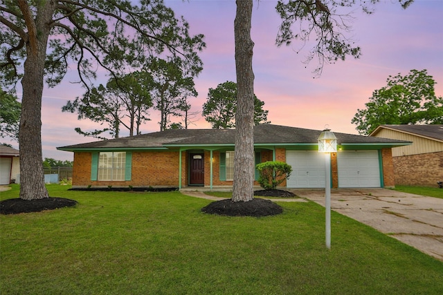 4517 Coachman Dr, Baytown, TX 77521 - view of front of home with a yard, an attached garage, brick siding, and driveway
