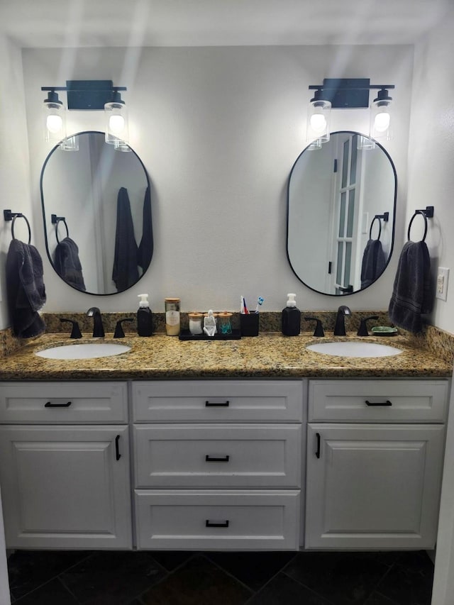 bathroom with double vanity, tile patterned flooring, and a sink