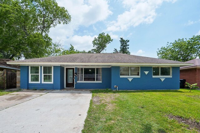 ranch-style house with concrete driveway, a front yard, and brick siding