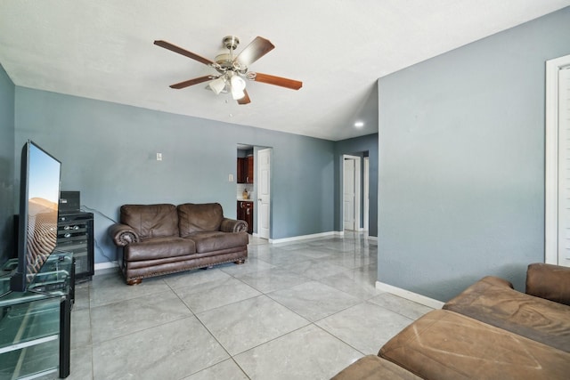 living room featuring baseboards and a ceiling fan