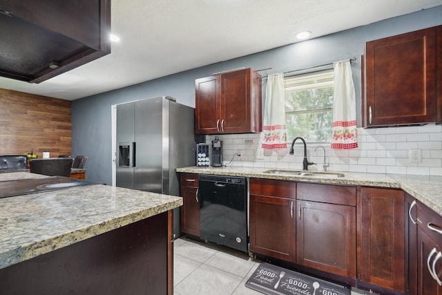 kitchen with light tile patterned floors, dark brown cabinets, a sink, black dishwasher, and backsplash