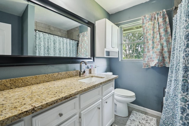 bathroom featuring toilet, baseboards, tile patterned floors, and vanity