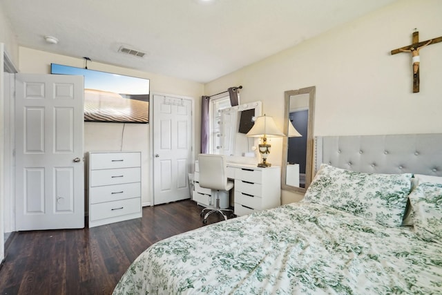 bedroom with visible vents and wood finished floors