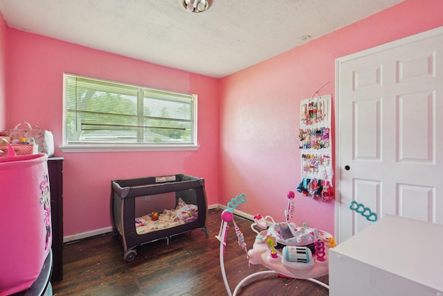 interior space featuring wood-type flooring and baseboards