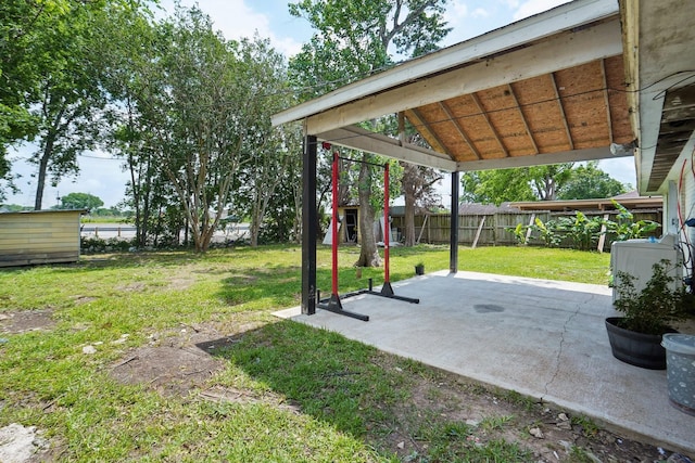 view of yard featuring a patio, an outdoor structure, a fenced backyard, and a storage unit