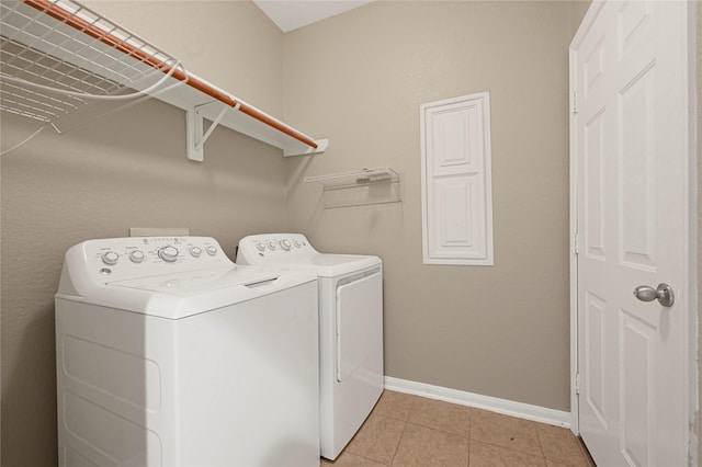 7431 Pony Crk, Missouri City, TX 77459 - clothes washing area with washing machine and dryer, baseboards, and light tile patterned floors